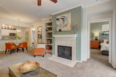 a living room with a fireplace and a table and chairs